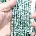 Macro shot of 3x6mm green and white natural stone spacer beads for DIY jewelry making - Qinghai Jade
