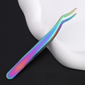Macro shot of rainbow-plated stainless steel curved tweezers on a white base - Rainbow