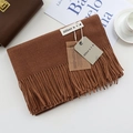 Detailed view of dark brown cashmere-like scarf with fringe and premium brand tags - Caramel / 200cm