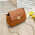 Brown quilted crossbody bag with golden heart lock and metal chain on wooden floor - Dark Brown