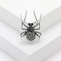 Spilla a forma di ragno vintage con cristalli neri e occhi di pietre verdi su base - Argento Nero