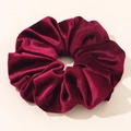 Detailed view of large burgundy velvet scrunchie with soft texture and glossy finish - Burgundy