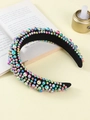 Wide velvet headband with colorful gradient iridescent pearls on a beige background - Colorful