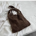 Close-up of brown knit tote bag showing thick wool woven texture on white bedding - Caramel (163)