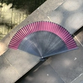 Elegant Chinese folding fan with dark red gradient fabric and black bamboo ribs - Hollow Crescent Black Red