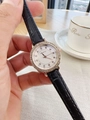Detail of luxury rhinestone watch with black leather strap on wrist in casual setting - Black