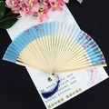Ancient style folding fan in sky blue silk with cherry blossom and blue tassel - Colored Cherry Blue Surface Light Handle