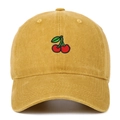 Close-up of fine cherry embroidery on mustard yellow washed cotton baseball cap texture - Yellow