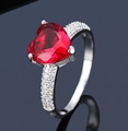 Elegant heart-cut red gemstone ring with micro-paved cubic zirconia in silver finish - Ur0650b