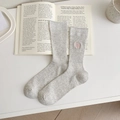 Light grey ribbed mid-calf socks with pink 'FUN TIME' embroidery in a cozy setting - One Size / Light Gray