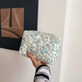 Handheld quilted cotton makeup bag featuring blue floral pattern on a beige base - New Blue Floral