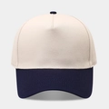 Detail of five-panel baseball cap showing reinforced stitching and navy blue contrast brim - Beige/Deep Blue