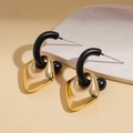 Detailed view of geometric black and gold earrings on a white stone display stand - Silver Earring Post - Gold - Rhombus