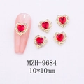 Macro detail of red heart nail charms with rhinestones and 10x10mm size markings - Pave Border Heart Nail Art Charm (9684)