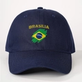 Detail view of navy blue cotton baseball cap featuring yellow BRASILIA text and flag - Adjustable / Navy Blue
