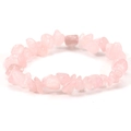 Macro shot of irregular pink crystal stones on an elastic bracelet against a white backdrop - Rose Quartz
