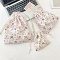 Three-piece set of embossed cartoon drawstring pouches on a marble desk for organization - Puppy Paradise