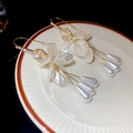 Macro view of vintage floral tassel earrings with white petals and pearls on ceramic plate - 4# Gold White Petal Pearl Tassel Style (4#)