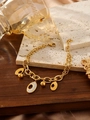 Dettaglio di un bracciale in acciaio al titanio placcato oro 18k con ciondolo di cristalli - Stile Strass Ovale(ZHB1079 Oro)