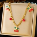 Double-layered gold stainless steel necklace with red enamel cherry charms on display - Red Cherry Enamel Necklace (N3122)