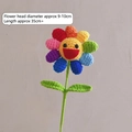 Handmade crochet rainbow sunflower with a yellow smiley face and green stem - Colorful Sunflower