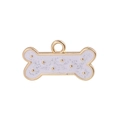 Detailed close-up of a bone-shaped golden alloy pendant with white glittery enamel inlay - 10Pcs White Bone Enamel Alloy Charms