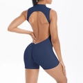 Rear view detail of navy blue yoga romper featuring backless design and ruched booty lifting - S / Navy Blue