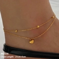 Close-up of double-layer gold anklet with heart pendant and beads worn on ankle - Gold (KA556)