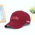 Detailed view of burgundy cotton baseball cap with 3D Devise embroidery and side text - Adjustable / Burgundy