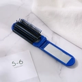 Spazzola per capelli pieghevole blu da viaggio con setole massaggianti e specchio - Blu scuro