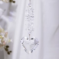 Macro detail of faceted heart-shaped crystal suncatcher hanging with prism beads - Transparent Heart