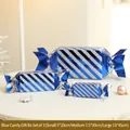 Tre scatole regalo blu a forma di caramella con strisce glitterate in tre dimensioni - Completo 3 Pezzi Blu