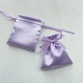 Two purple satin drawstring pouches with silk ribbons on white textured surface - 12x14cm / Light Purple