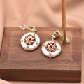 Vintage style gold earrings with white pearl base and red zircon stones on silk - Geometric Round Flat Pearl Earrings