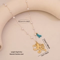 Faux pearl necklace with golden octopus and blue coral pendant on beige display stand - Octopus Style