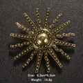 Golden sunburst pearl brooch with vintage industrial design on textured black background - Sunburst Radiating Style (XD7507) / Gold
