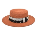 Close-up of caramel boater hat with black ribbon, white pearls and sparkling crystals - Caramel color