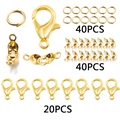 100pcs golden DIY jewelry making set including lobster clasps and jump rings on white background - Gold Set
