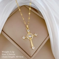 Detail of a gold cross pendant necklace with sparkling micro-inlaid zircon on white silk - Micro Inlaid Cross Style (A305)