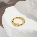 Macro shot of gold beaded elastic ring with evil eye charm on white stone texture - Eye Charm Style (ZYN-DMR144G-5)
