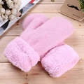 Pink knitted mittens with thick faux fur cuffs for women on a cozy wooden surface - Pink