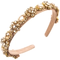 Macro shot of luxury crystal floral headband with champagne rhinestones on fabric base - Coffee