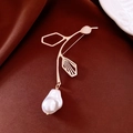 Macro detail of bird brooch with pink gemstone and baroque pearl on silk fabric - Bird Flower Branch Style / Gold