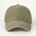 Detailed close-up of khaki washed cotton baseball cap with green lucky clover print - One Size / Dark Khaki