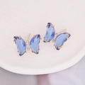Elegant butterfly stud earrings featuring deep blue crystals and gold plated metal - Royal Blue