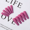 Detail view of purple matte ballerina press-on nails arranged on aesthetic white paper - Lotus Pink