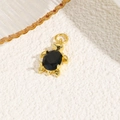 Detailed view of an 18k gold-plated turtle pendant with a black oval gemstone inlay - Black (Turtle Style A)