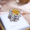 Luxurious silver cocktail ring with large yellow rectangular gem and marquise halo detail - Adjustable Open / Yellow