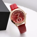 Close-up of rose gold diamond-encrusted watch with red leather strap and textured dial - Red