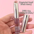 Silicone lip and concealer brush with silver cap and transparent tube in hand - Bright Silver Transparent Rod (Transparent Silicone)